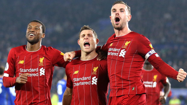 James Milner of Liverpool celebrates after scoring his side's second goal with Jordan Henderson and Georginio Wijnaldum against Leicester City at The King Power Stadium on December 26.