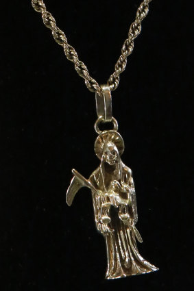 A necklace made of white gold with a pendant in the image of "Holy Death", which was on display but removed from the auction due to the image it represents.