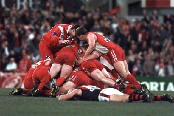 The Swans celebrate a famous win after the siren.