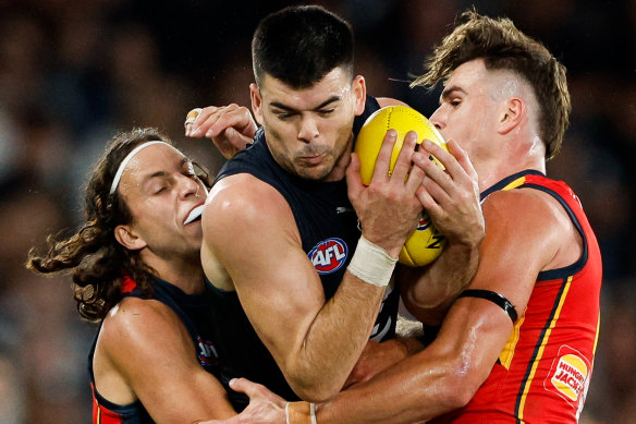 Matthew Kennedy of the Blues is tackled by Will Hamill and Ben Keays of the Crows.