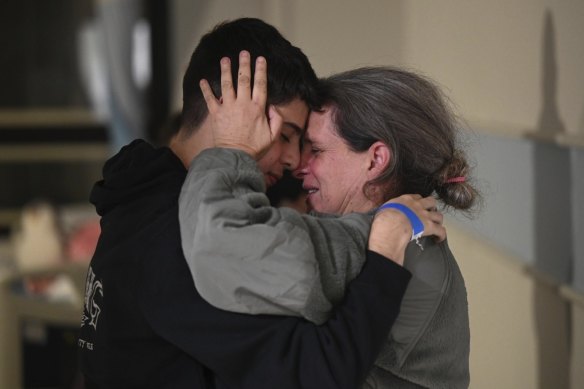 Sharon Hertzman, part of the second batch of hostages to be released, embraces a relative as they reunite at Sheba Medical Centre in Ramat Gan, Israel. Her daughter Noam, 12, not pictured, was also released.