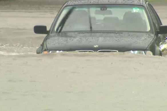 A car driving through floodwaters in Heathcote, against SES advice.