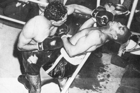 Australian Boxer Dave Sands has American Henry Brimm on the ropes before knocking him out in round two at the Sydney Stadium in Rushcutters Bay on August 7, 1950.