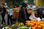 SYDNEY, AUSTRALIA - OCTOBER 22: People shop for fruit and vegetable produce at Paddy's Market on October 22, 2022 in Sydney, Australia. Treasurer Jim Chalmers will deliver the first Federal Budget for the Albanese Labor Government on October 25, 2022 - warning Australians to brace for spending cuts and limited cost-of-living relief. Focussing on rising inflation (6.1 per cent in the June Quarter) and a darkening world economy. The budget will include lower priced medicines, available from Januar