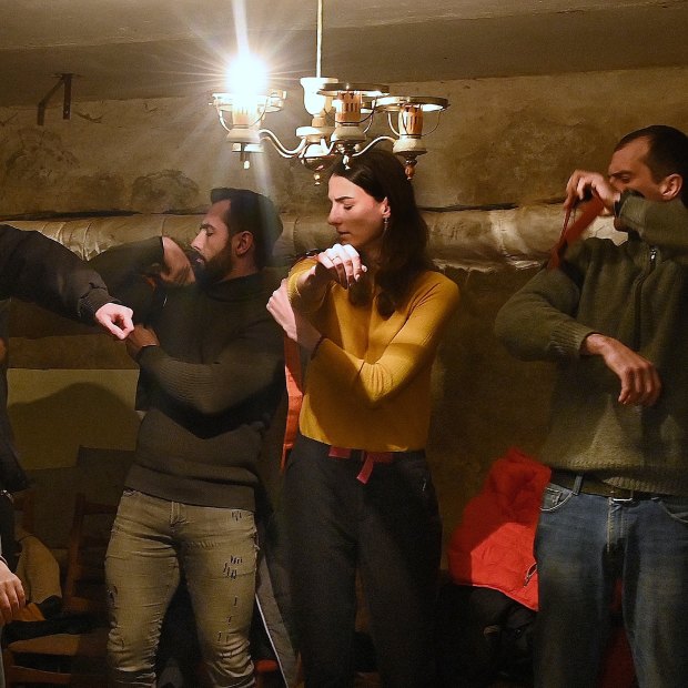 Civilians learned how to apply a tourniquet in an underground shelter during an air raid in Dnipro. 