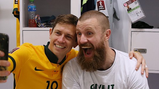 Craig Goodwin and Andrew Redmayne celebrate a famous Socceroos victory.