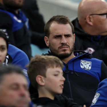 An injured Josh Reynolds watches his Bulldogs teammates from the stands before taking aim at the chairman in the sheds after full-time.