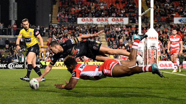 Brent Naden outleaps Mikaele Ravalawa to touch down for the Panthers.