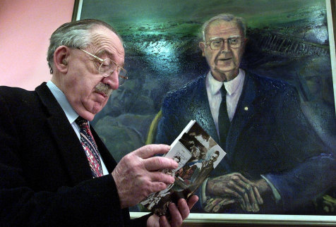 Dr John Duggan with the large portrait  of his colleague Dr Roy Mills at the John Hunter Hospital Library. 
