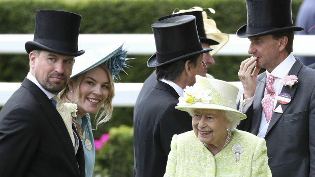 The Queen with her grandson, Peter Phillips, left, and his wife Autumn in June last year.