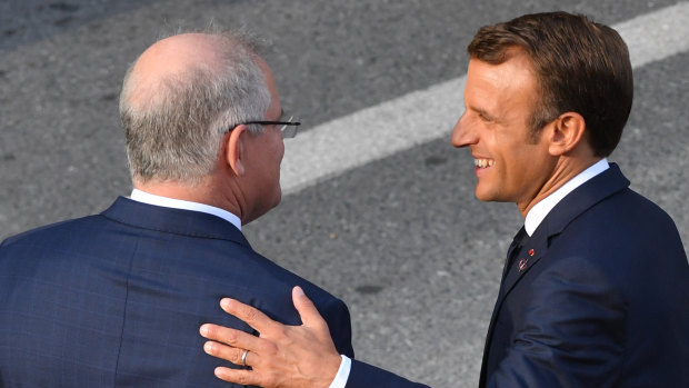 Prime Minister Scott Morrison and French President Emmanuel Macron meet in the street in Biarritz.