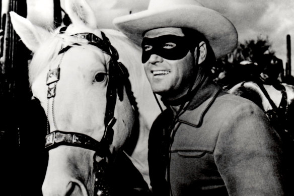 Clayton Moore in his role as The Lone Ranger, crusading against villains on his horse Silver. 