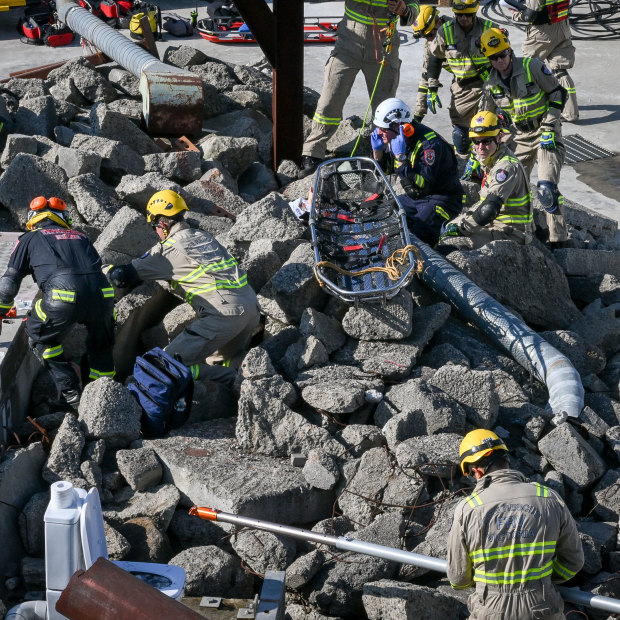 Urban search and rescue teams look for survivors in the rubble.