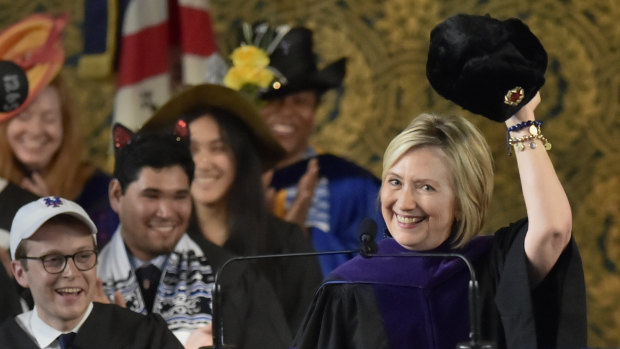 Hillary Clinton holds up a Russian fur hat, an ushanka, with a Soviet era hammer and sickle emblem, to the Yale College class of 2018 during her Class Day address at Yale University