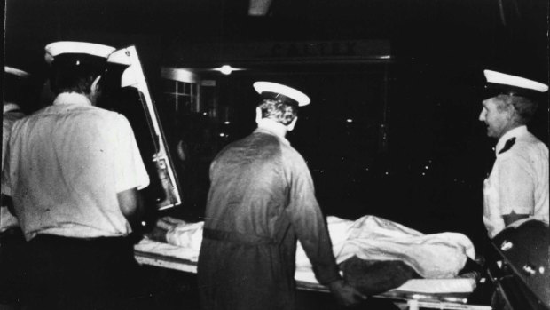 Ambulance officers transport a victim of the Whiskey Au Go Go fire, March 8, 1973