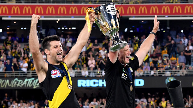 Trent Cotchin and Damien Hardwick lift the premiership cup.