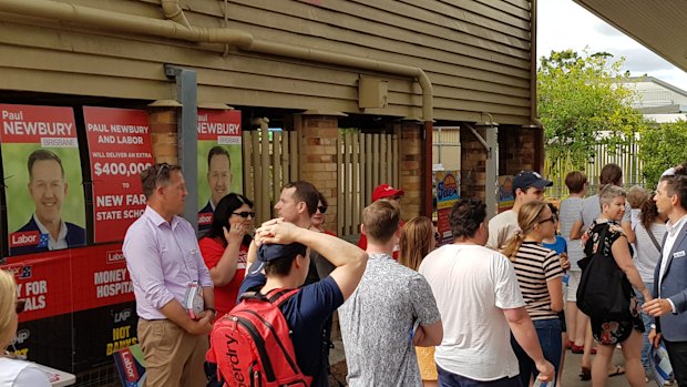 Battle lines - Labor candidate for Brisbane Paul Newbury (left) and LNP incumbent Trevor Evans work either side of the voting line at New Farm state school