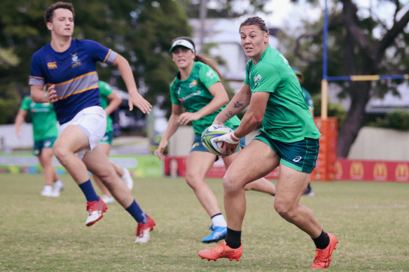 Sharni Williams launches an attacking raid during a training contest between the Australian sevens team and the Churchie first XV.