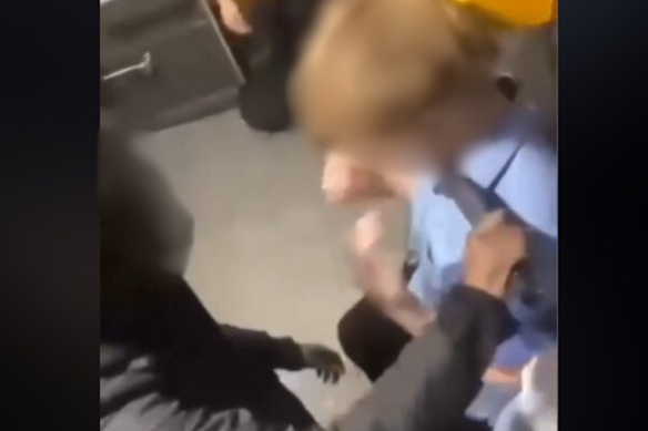 A boy is seen being threatened with a machete.