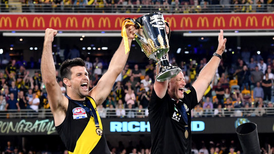 Trent Cotchin and Damien Hardwick lift the premiership cup.