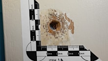 A ballistics expert told the court an examination of the bedroom door two years later provided evidence a gun was fired through it.