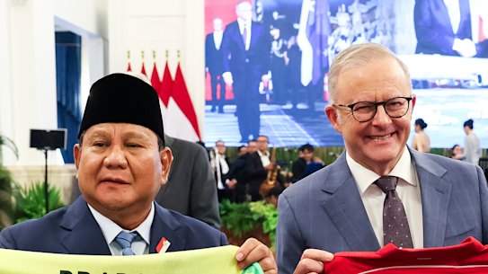 President of Indonesia Prabowo Subianto and Prime Minister Anthony Albanese exchange jerseys during lunch at Merdeka Palace in Jakarta.