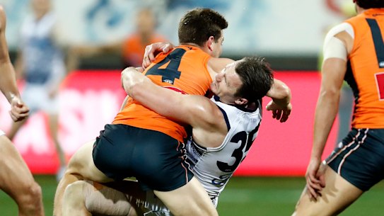 Toby Greene tries to fend off Patrick Dangerfield.