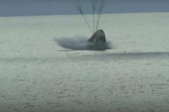 The SpaceX capsule splashes down in the Atlantic.