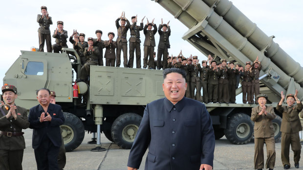 North Korean leader Kim Jong-un smiles at the test-firing of an unspecified missile at an undisclosed location. 