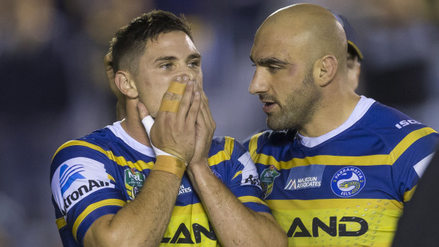Mitchell Moses is consoled by Tim Mannah after a loss in 2018.