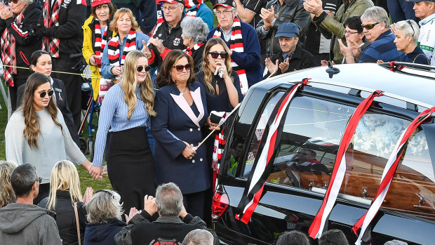 Danny Frawley's wife and daughters walk behind his hearse at Moorabbin Oval.