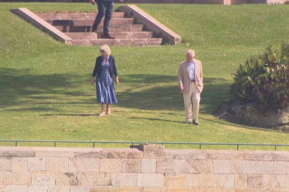 Queen Camilla and King Charles III on a walk around the grounds of Admiralty House on Saturday.