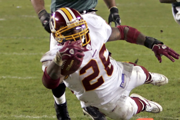 Clinton Portis dives for a touchdown while playing for the Washington Redskins in 2006.