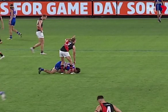 Essendon’s Darcy Parish signals for assistance after Tom Liberatore collapsed