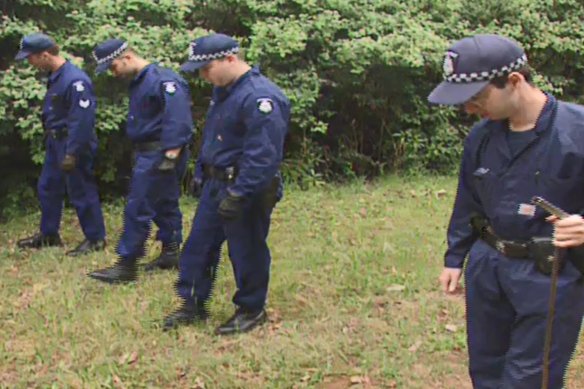Officers search bushland in the Dandenong Ranges area as part of Operation Collier.
