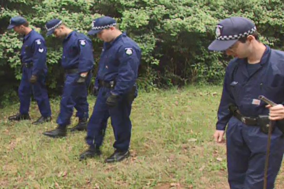 Officers search bushland in the Dandenong Ranges area in 1998 as part of Operation Collier.