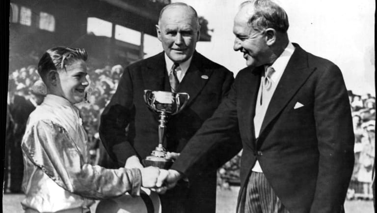 Mr. H. G. Raymond with Jockey Ray Neville, after their 1948 Melbourne Cup success with Rimfire.