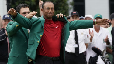 Feels good: Tiger Woods tries on his fifth Masters green jacket for size.