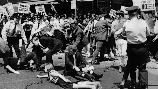 Police move people protesting the visit of American President Lyndon B.  Johnson in Liverpool Street
