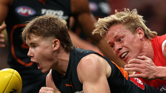 Harvey Thomas of the Giants is tackled by Isaac Heeney 