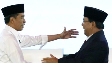 Indonesian President Joko Widodo, left, and his contender Prabowo Subianto shake hands after a televised debate last month.
