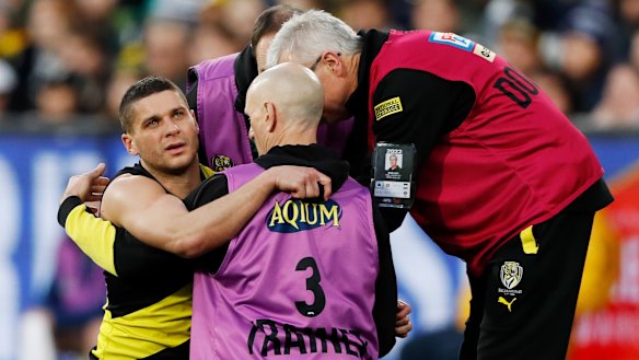 Prestia is helped to his feet after the heavy knock.