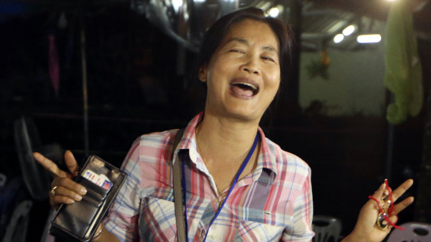 A family member smiles after hearing the news that the missing 12 boys and their soccer coach had been found, in Mae Sai, Chiang Rai province.