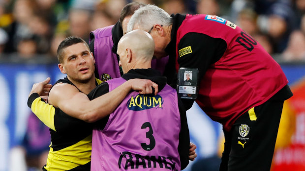 Prestia is helped to his feet after the heavy knock.