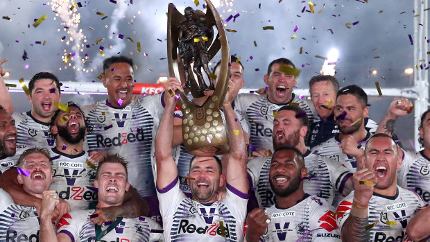 The Storm celebrate with the premiership trophy at ANZ Stadium on Sunday.