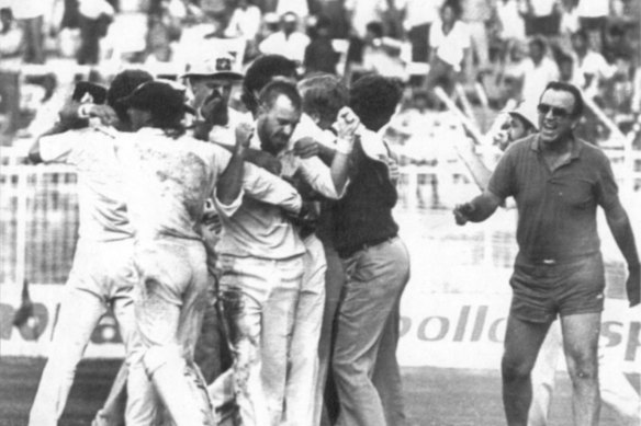 Manager Bobby Simpson, the only person to have participated in two tied Tests runs onto the field to congratulate last-over hero Greg Matthews.