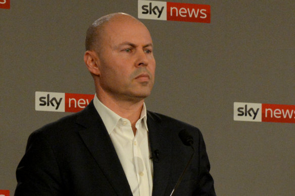 Treasurer Josh Frydenberg listens as his rival speaks at the debate.