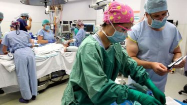 Surgeons perform a  heart and lung transplant. 