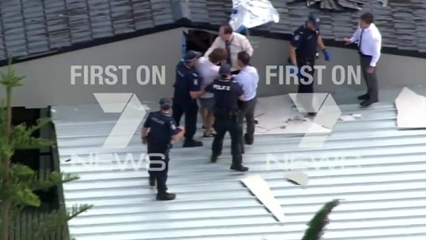 Police arrest accused killer Ryan John Howes on a Gold Coast rooftop in 2015.