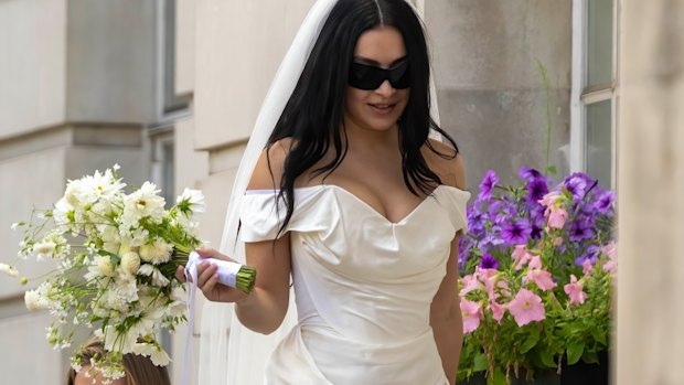 Charli XCX dials down the lace in a Vivienne Westwood minidress at her July 2025 wedding.